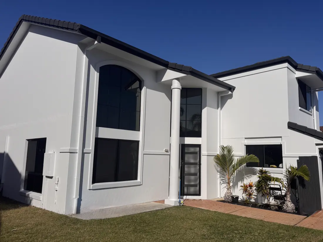 The same house after repainting — clean white render