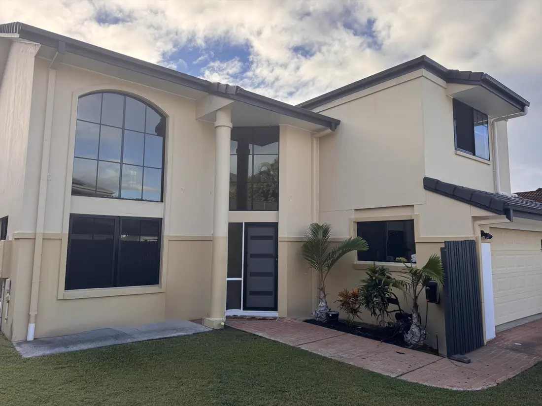 Ashmore house exterior before repainting — chalky cream render